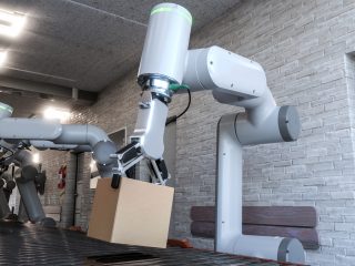 Dos cobots trabajando cogiendo cajas.